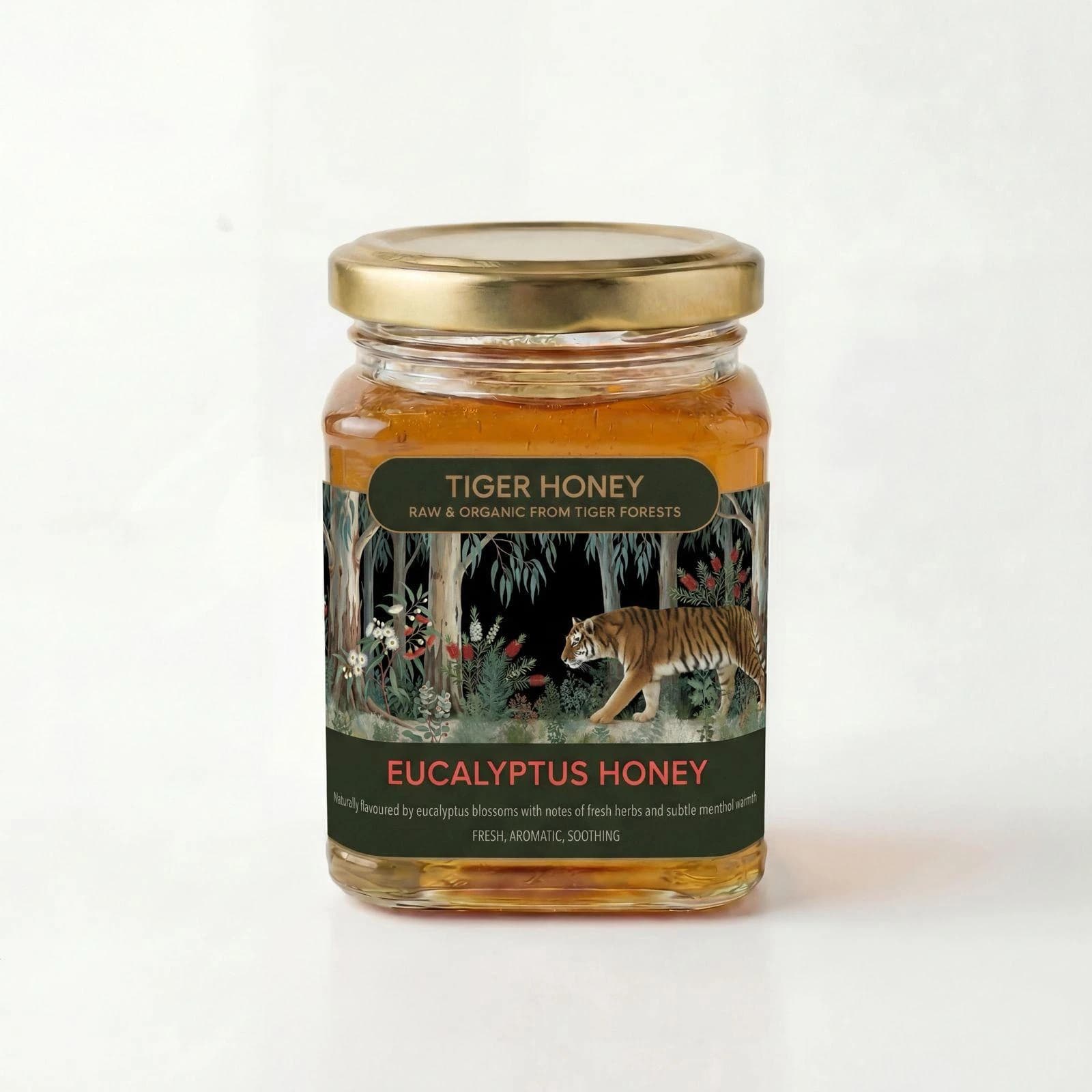 Studio photograph of a glass jar of golden Eucalyptus Honey with blue-green eucalyptus leaves