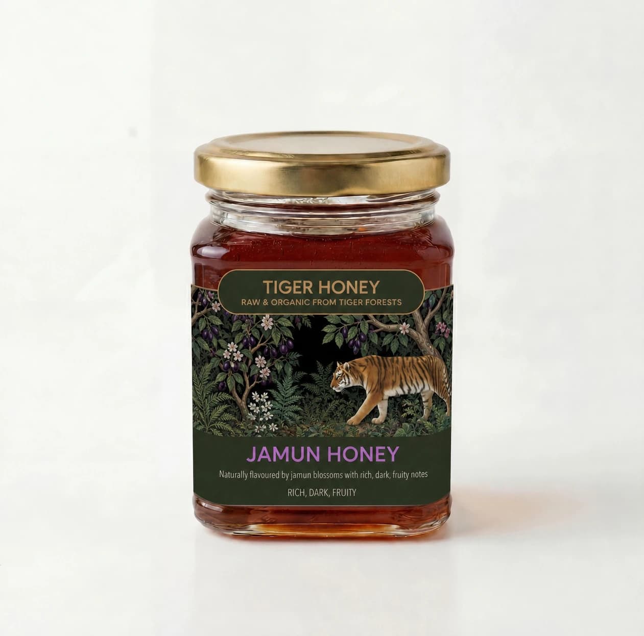 Studio photograph of a glass jar of dark amber Jamun Honey with jamun leaves, blossoms, and fruit